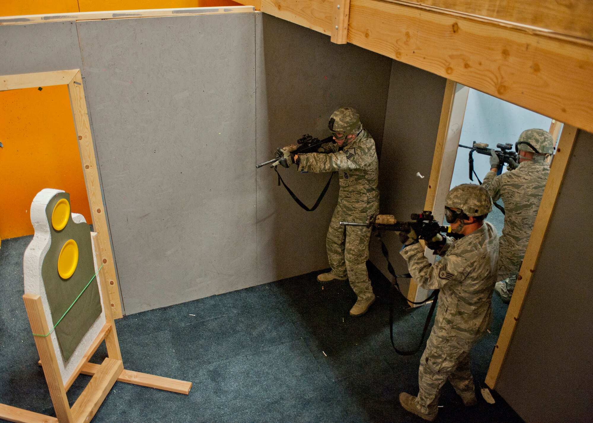 Participants in the Warrior Challenge clear a room inside the shoot house during the contest at Nellis Air Force Base, Nev., May 29, 2015. During the simunitions room clearing, Airmen cleared and shot targets throughout the shoot house, which is a simulated house built to give Airmen realistic room-clearing training. (U.S. Air Force photo by Airman 1st Class Jake Carter)