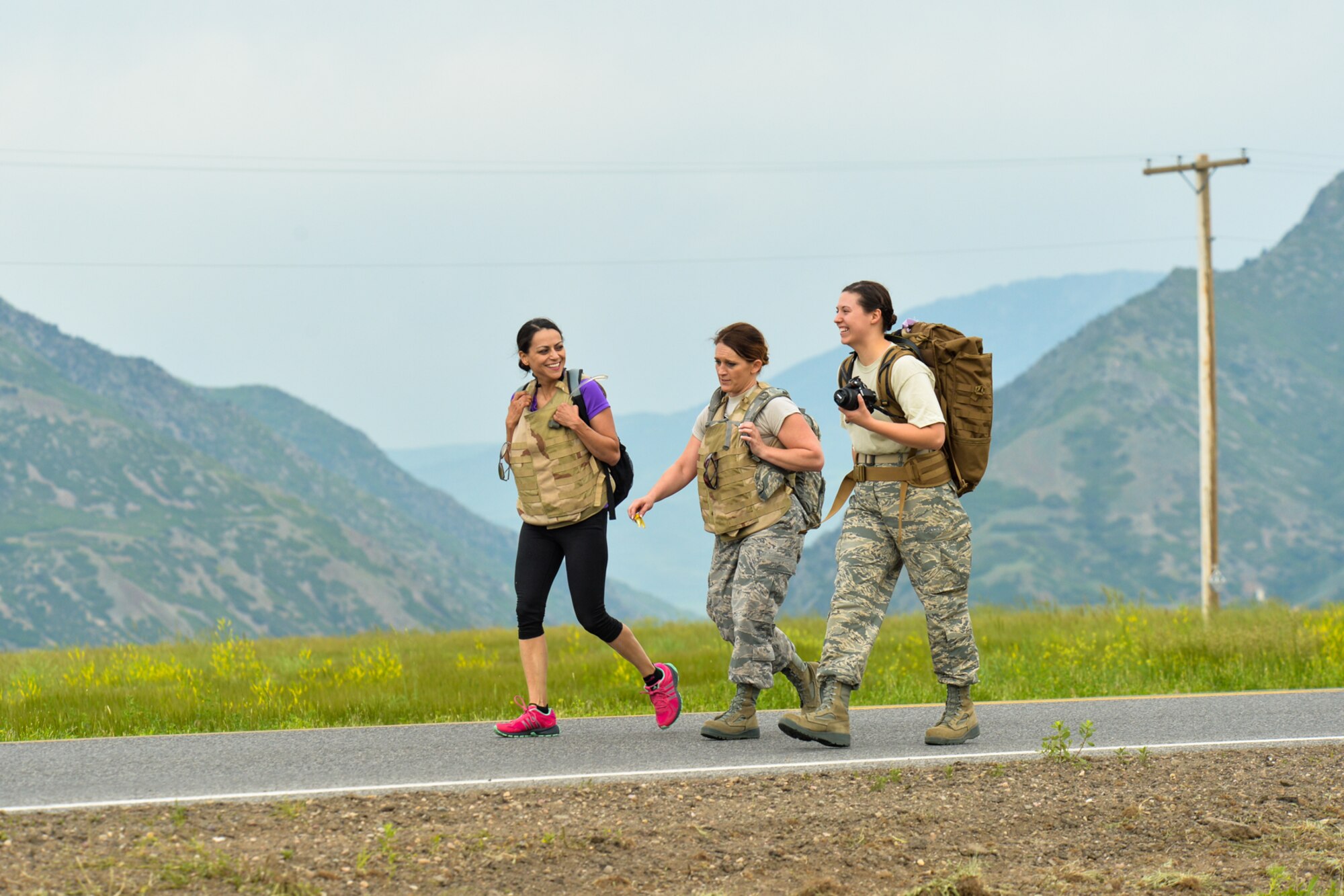 Senior Master Sgt. Miranda Sayre, Tech. Sgt. Heather Nevius, and Senior Airman Barbara Aguirre, all from the 419th Medical Squadron, participate in the 8th Annual Ruck March along the 13-mile perimeter road of Hill Air Force Base June 5. (U.S. Air Force photo/R. Nial Bradshaw) 