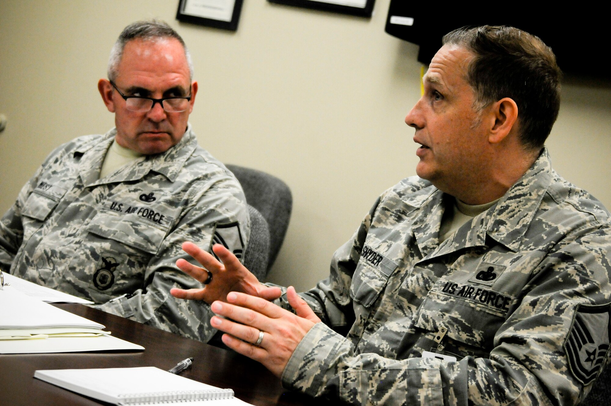 Master Sgt. Micah Snyder, command security forces inspector stationed at Joint Base Langley-Eustis, Va., talks with Senior Master Sgt. Larry Laney, 188th Security Forces Squadron Wing Inspection Team member, and Master Sgt. Chad West, 188th Security Forces Squadron non-commissioned officer in charge of training, about the current status of the training program in the 188th SFS. Snyder offered advice and techniques for enhancing the WIT member’s inspection and also how program managers can better prepare themselves for future inspections. (U.S. Air Force photo by Capt. Holli Nelson) 