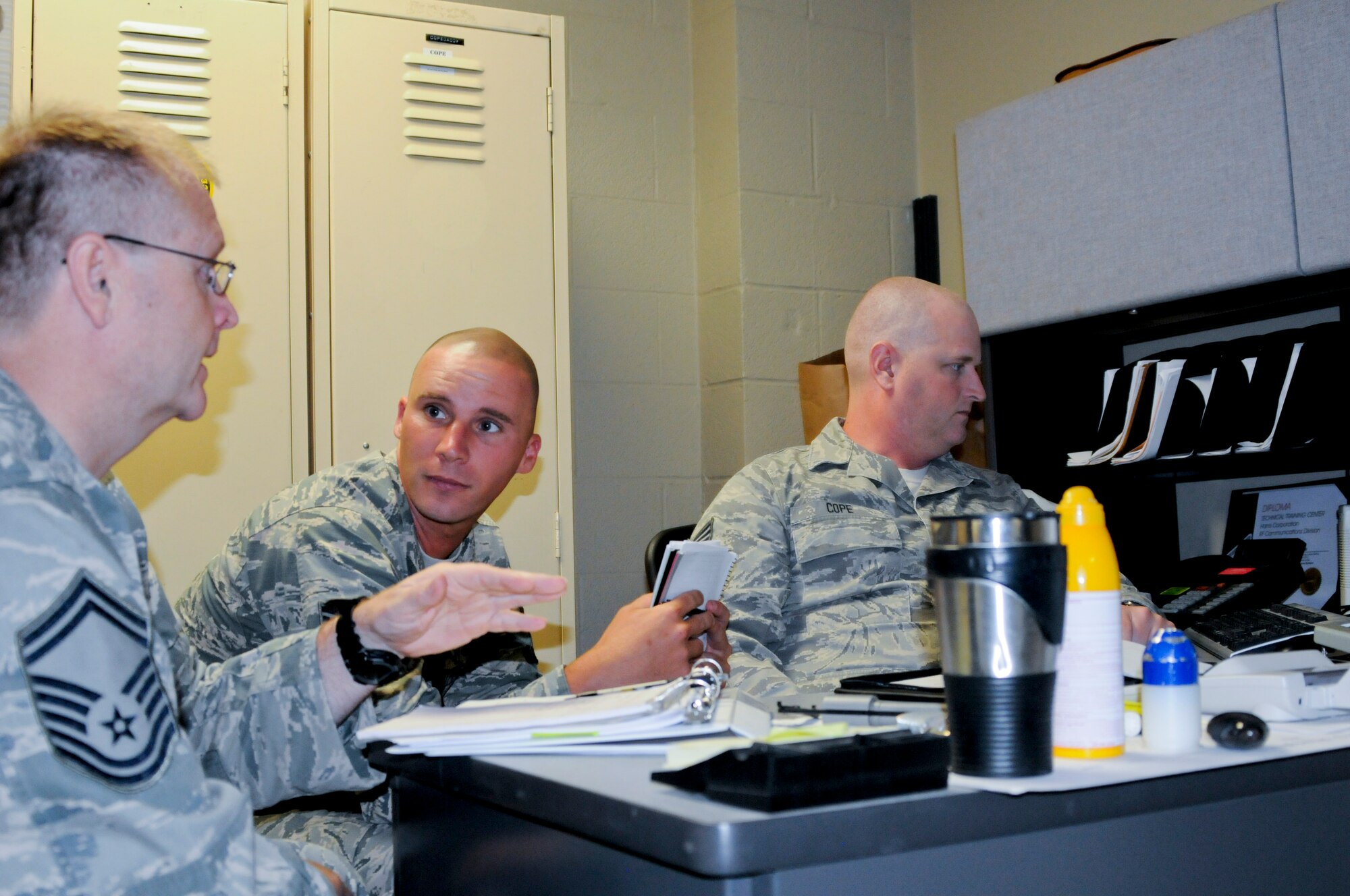 Tech. Sgt. Terry Bufkin (center), command security forces inspector stationed at Joint Base Langley-Eustis, Va., goes over self-inspection checklist items with Senior Master Sgt. Edgar Mahan and Tech Sgt. Joseph Cole, both assigned to the 188th Security Forces Squadron. The ACC IG inspectors spent two days visiting Security Forces and Civil Engineer Squadrons and working with Wing Inspection Team members on the proper techniques and procedures while conducting program inspections. (U.S. Air Force photo by Capt. Holli Nelson)