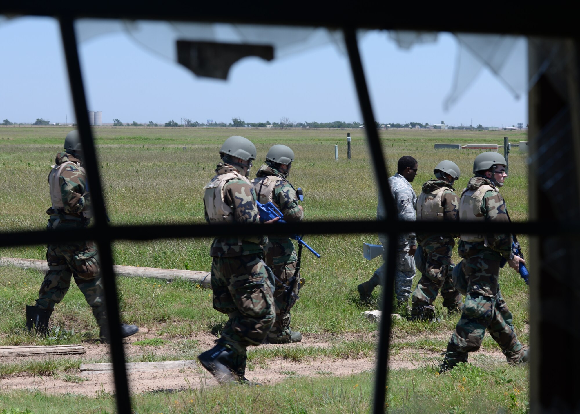 ALTUS AIR FORCE BASE, Okla. -- U.S. Air Force contracting Airmen search for potential improvised explosive devices, June 3, 2015. This is the second year Altus Air Force Base and Sheppard Air Force Base, Texas contracting offices have teamed up to participate in a deployment exercise. (U.S. Air Force photo by Airman 1st Class Kirby Turbak/Released)