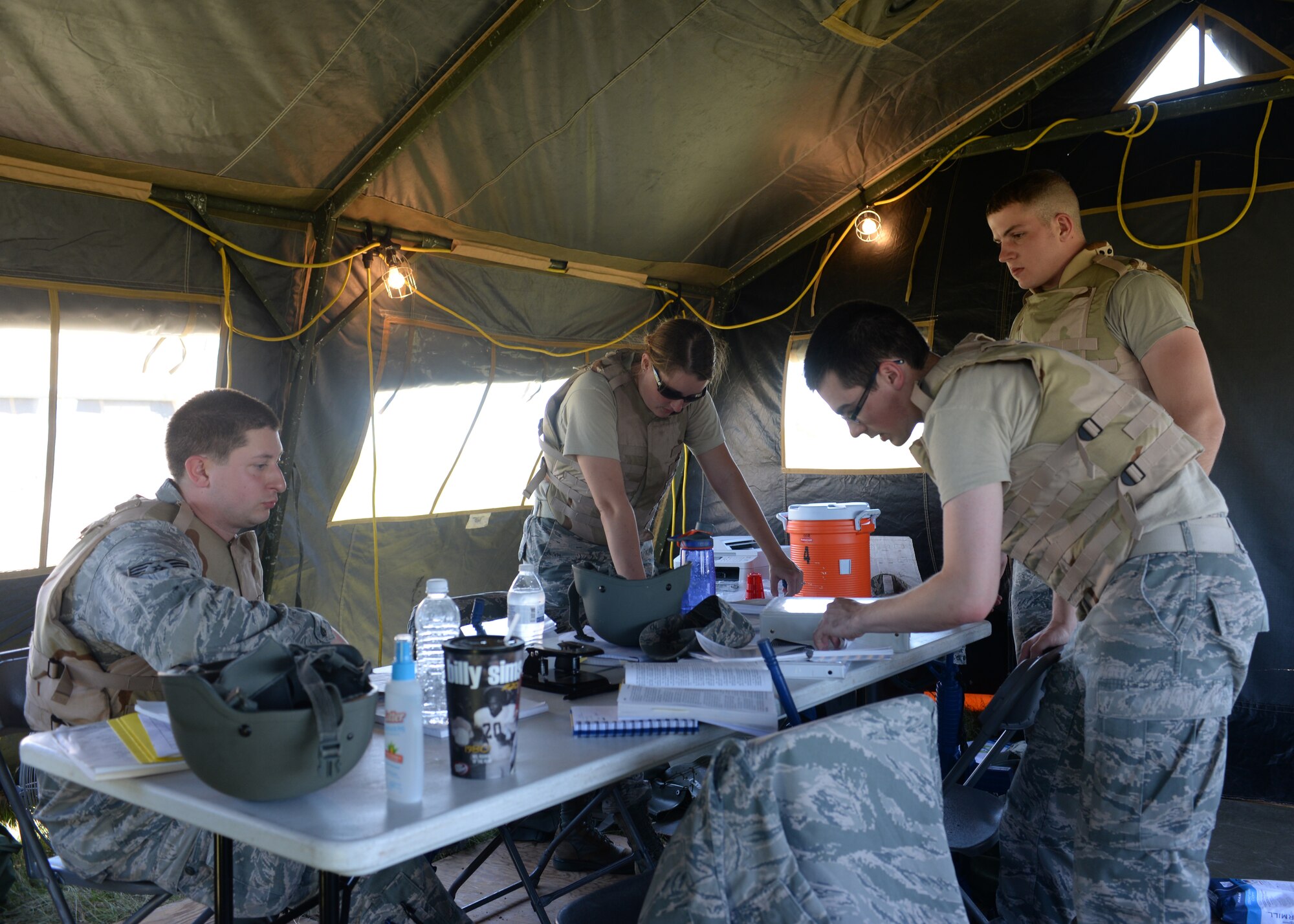 ALTUS AIR FORCE BASE, Okla. -- U.S. Air Force contract specialists from Altus Air Force Base and Sheppard Air Force Base, Texas prepare contracts for simulated vendors, June 3, 2015. The Airmen had to complete simulated contracts to provide their base with water and other essentials. (U.S. Air Force photo by Airman 1st Class Kirby Turbak/Released)