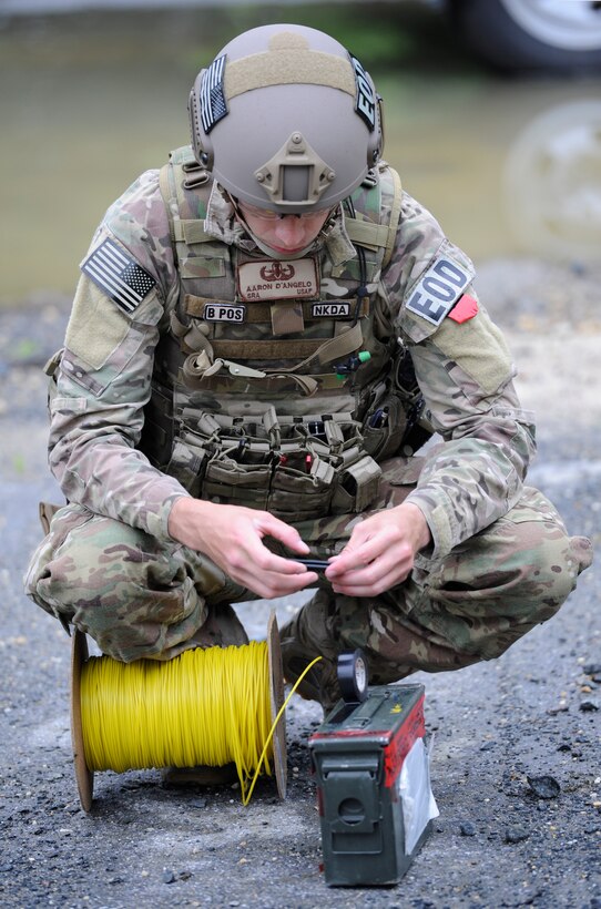 Senior Airman Aaron D’Angelo, 11th Civil Engineer Squadron Explosive Ordnance Disposal journeyman,   assembles a detonation device to dispose of a simulated Improvised Explosive Device June 4, 2015, on Joint Base Andrews, Md. EOD technicians can dispose of devices in a number of ways, one is to clear the area and detonate the device as intended. (U.S. Air Force photo by Senior Airman Preston Webb/Released)