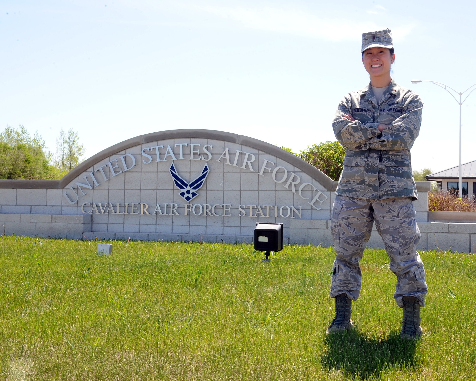 2nd Lt. Ashley Newberry, 10th Space Warning Squadron chief of operations training, stands at the front gate of Cavalier Air Force Station, N.D. June 4, 2015. Newberry was selected to be the Grand Forks Air Force Base, N.D. Warrior of the Week for the first week of June. (U.S. Air Force photo by Senior Airman Zachiah Roberson/released)
