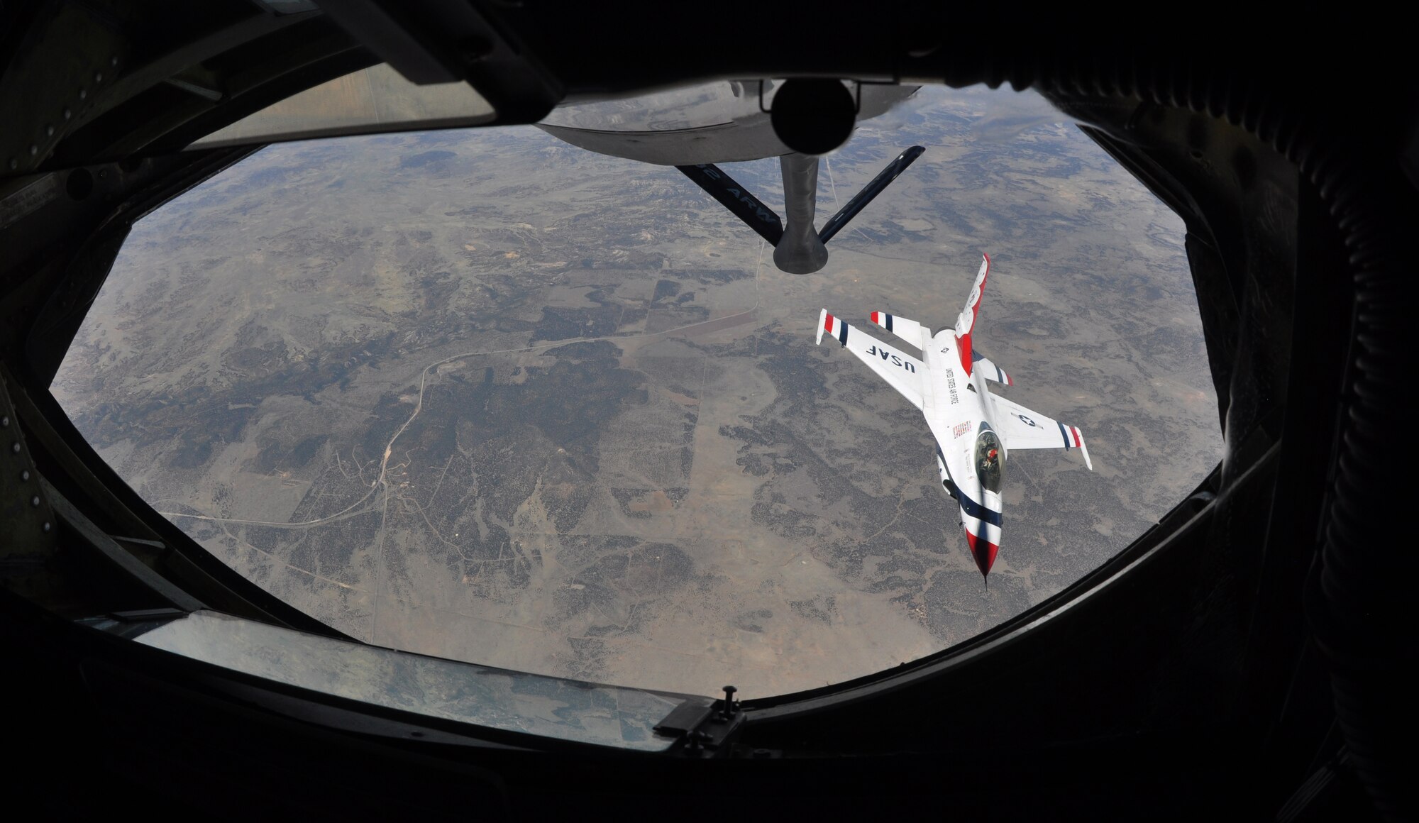 A member of the U.S. Air Force Thunderbirds Air Demonstration Squadron, flies a F-16 Fighting Falcons back into formation after an air refueling from a KC-135 Stratotanker assigned to McConnell Air Force Base, Kan., June 4, 2015. The KC-135 provided cross-country air refueling support for the Thunderbirds. The KC-135 aircrew, all Air Force Reservists from the 931st Air Refueling Group, performed fourteen air refueling contacts during the mission. The squadron was on their way to the Heart of Texas Airshow in Waco, Texas, June 6-7. The squadron performs approximately 75 demonstrations each year and has never canceled a demonstration due to maintenance difficulty. More than 300 million people in all 50 states and 58 foreign countries have seen the red, white and blue jets in more than 4,000 aerial demonstrations. (U.S. Air Force photo by Tech. Sgt. Abigail Klein)