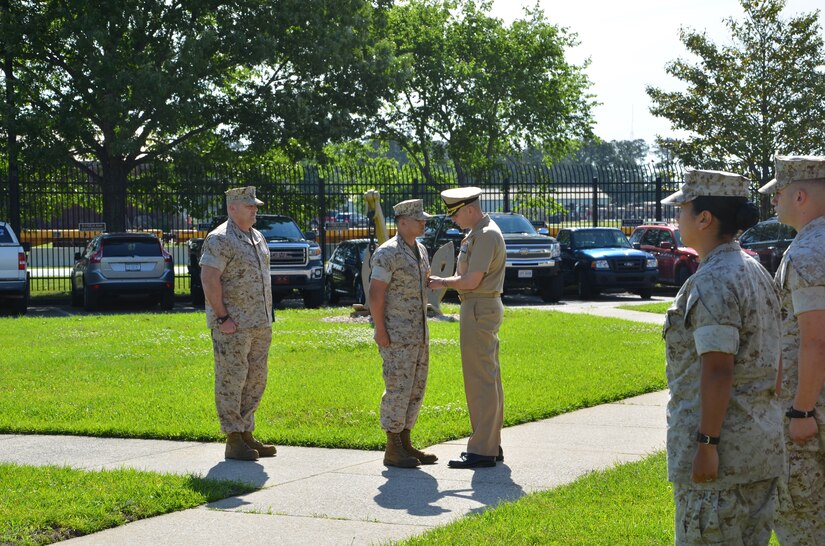 Commander J. Michael Cole pins the Navy and Marine Corps Commendation Medal on Lance Cpl. Victor Padilla during a ceremony April 21, 2015 at the Naval Consolidated Brig Charleston on Joint Base Charleston, S.C. Padilla was awarded the medal for saving his best friend and fellow marine from a suicide attempt on April 11, 2015. The Navy and Marine Corps Commendation Medal is reserved for Sailors and Marines who distinguish themselves through heroic or meritorious achievement. Cole is the commanding officer of the NCBC and Padilla is a correction specialist at NCBC. (Courtesy photo / Naval Consolidated Brig Charleston) 