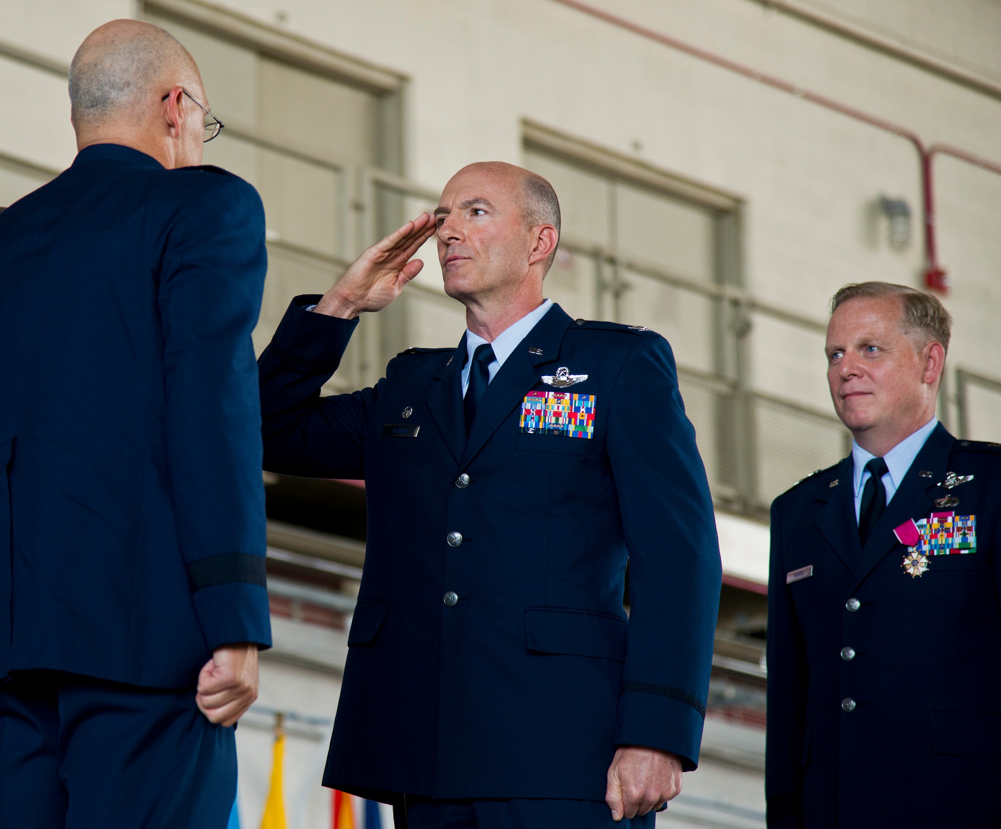 Col. Christopher Azzano salutes after taking command of the 96th Test Wing during the change of command ceremony June 4 at Eglin Air Force Base, Fla.  Azzano took the reins of the wing from Maj. Gen. David Harris (right), who leaves to take command of the Air Force Test Center. (U.S. Air Force photo/Samuel King Jr.)