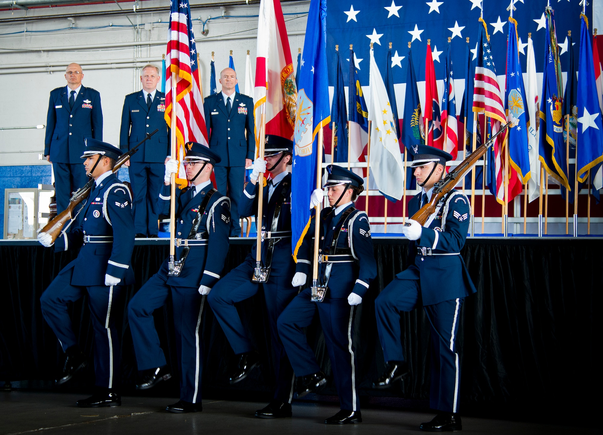 The base honor guard brings in the colors and old and new wing leadership watch during the 96th Test Wing change of command ceremony June 4 at Eglin Air Force Base, Fla.  Col. Christopher Azzano took the reins of the wing from Maj. Gen. David Harris, who leaves to take command of the Air Force Test Center.  (U.S. Air Force photo/Samuel King Jr.)
