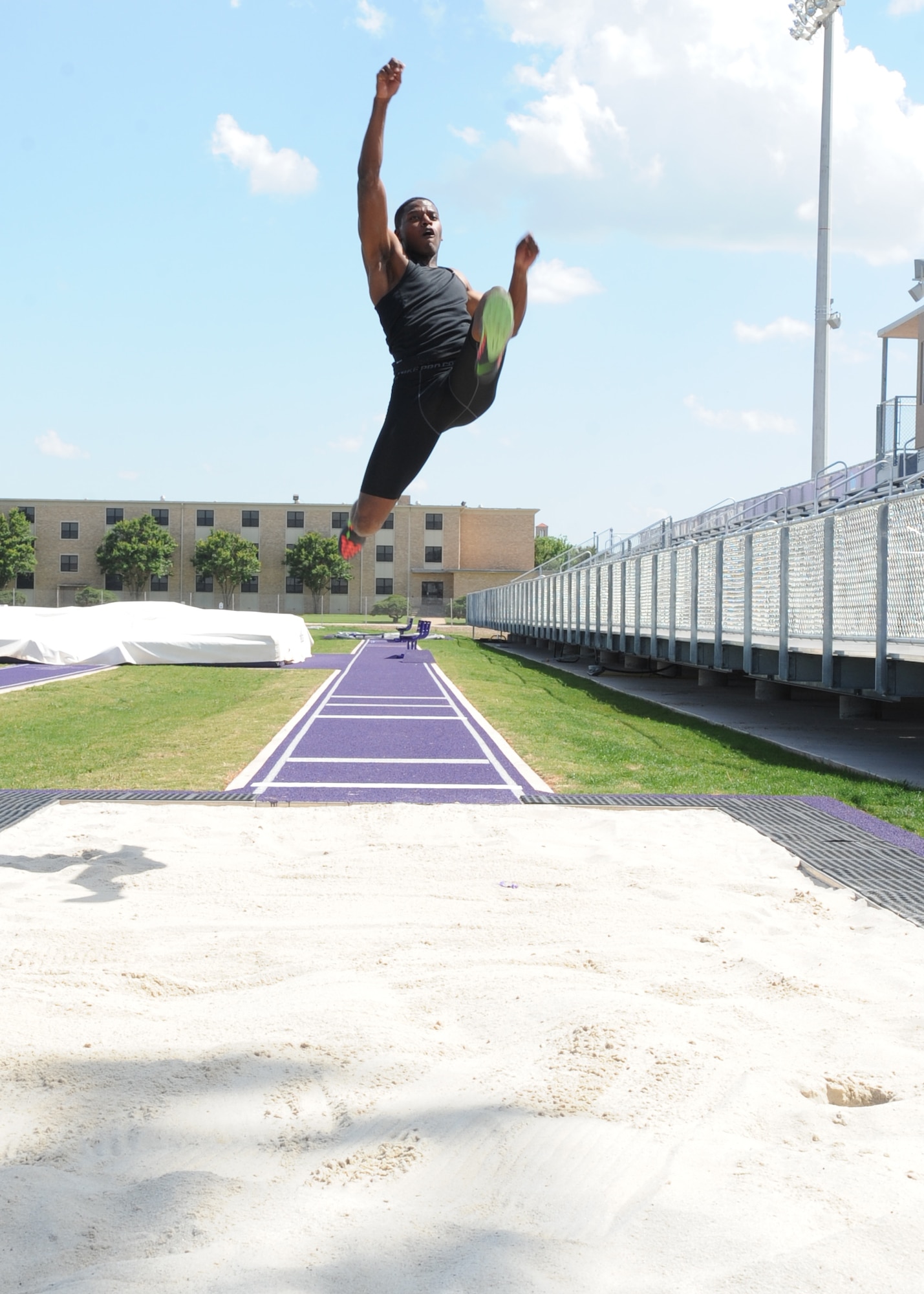 U.S. Air Force Senior Airman Parnelle Shands, 317th Aircraft Maintenance Squadron crew chief, practices his long jump at Abilene Christian University May 18, 2015, in Abilene, Texas. Shands competed in long jump at the 2015 Headquarter Air Command Track and Field Championship and won 1st place. (U.S. Air Force photo by Senior Airman Shannon Hall/Released)