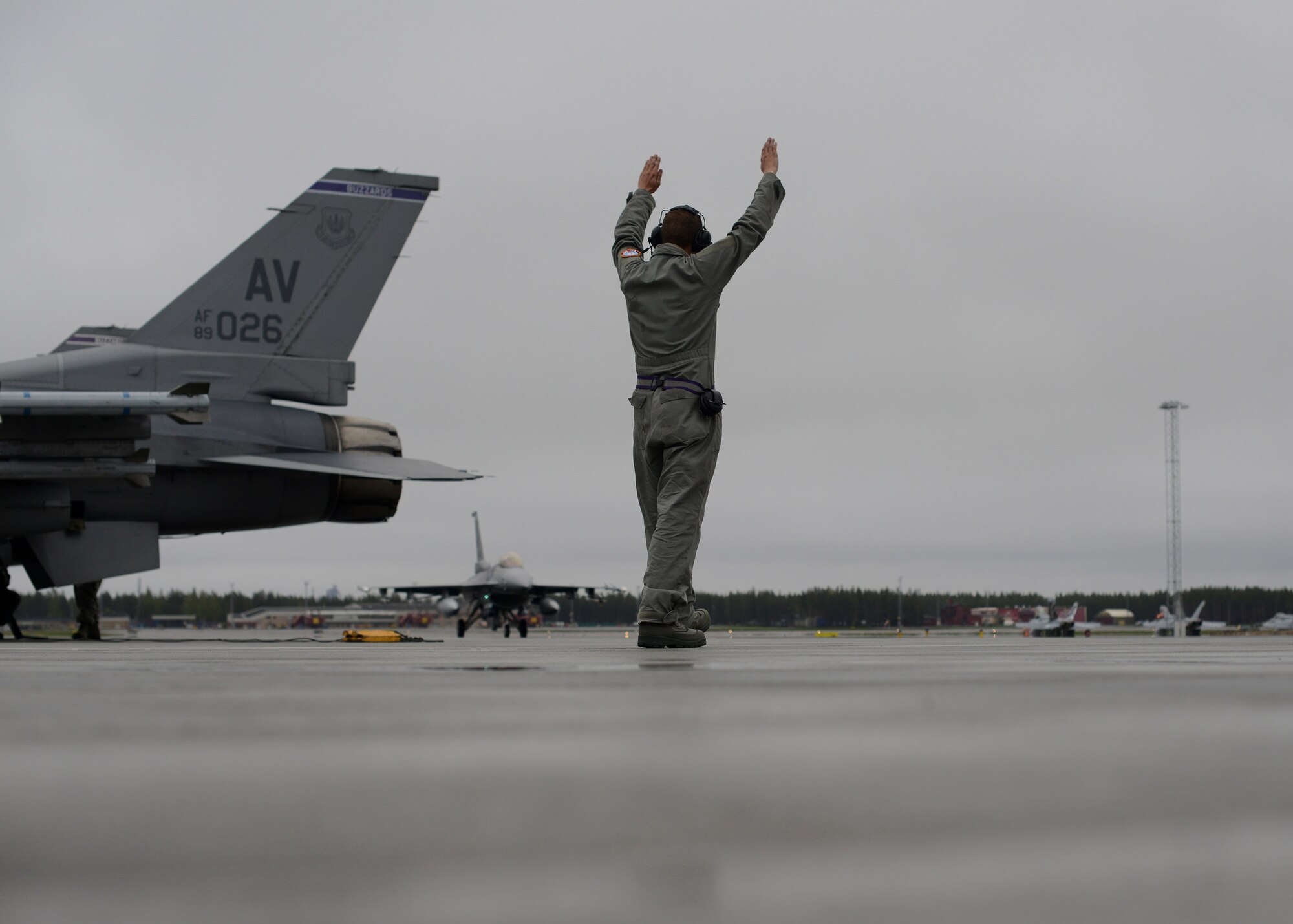 U.S. Air Force Airman 1st Class Bryce Quick, 31st Aircraft Maintenance Squadron crew chief, taxi’s an F-16 Fighting Falcon with the 510th Fighter Squadron from Aviano Air Base, Italy at Kallax Air Base, Sweden, June 1, 2015 during Arctic Challenge Exercise 2015.  Nine nations participated in the exercise to help ensure interoperability and strengthen relationships with NATO allies and Partners for Peace.(U.S. Air Force photo by Staff Sgt. Evelyn Chavez/Released)