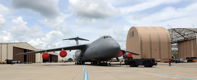 A C-5M is towed from a 559th Aircraft Maintenance Squadron repair facility at Robins, May 27, 2015. (U.S. Air Force photo by Tommie Horton)