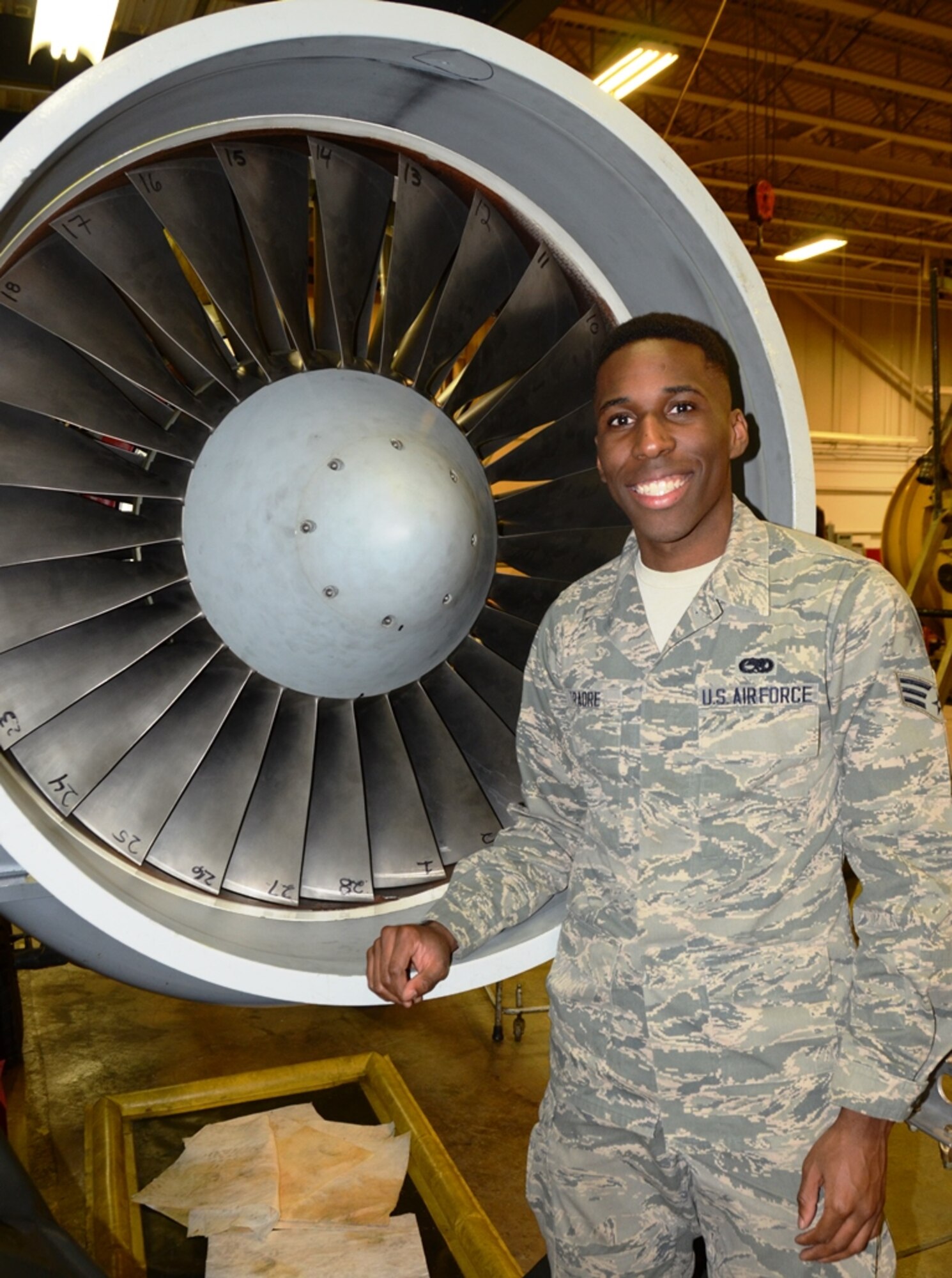Senior Airman Jordan Traore, 175th Maintenance Squadron, stands in front of an engine for an A-10C Thunderbolt II. Traore is the June spotlight Airman in the Maryland Air National Guard. (U.S. Air National Guard photo by Tech. Sgt. David Speicher/RELEASED)