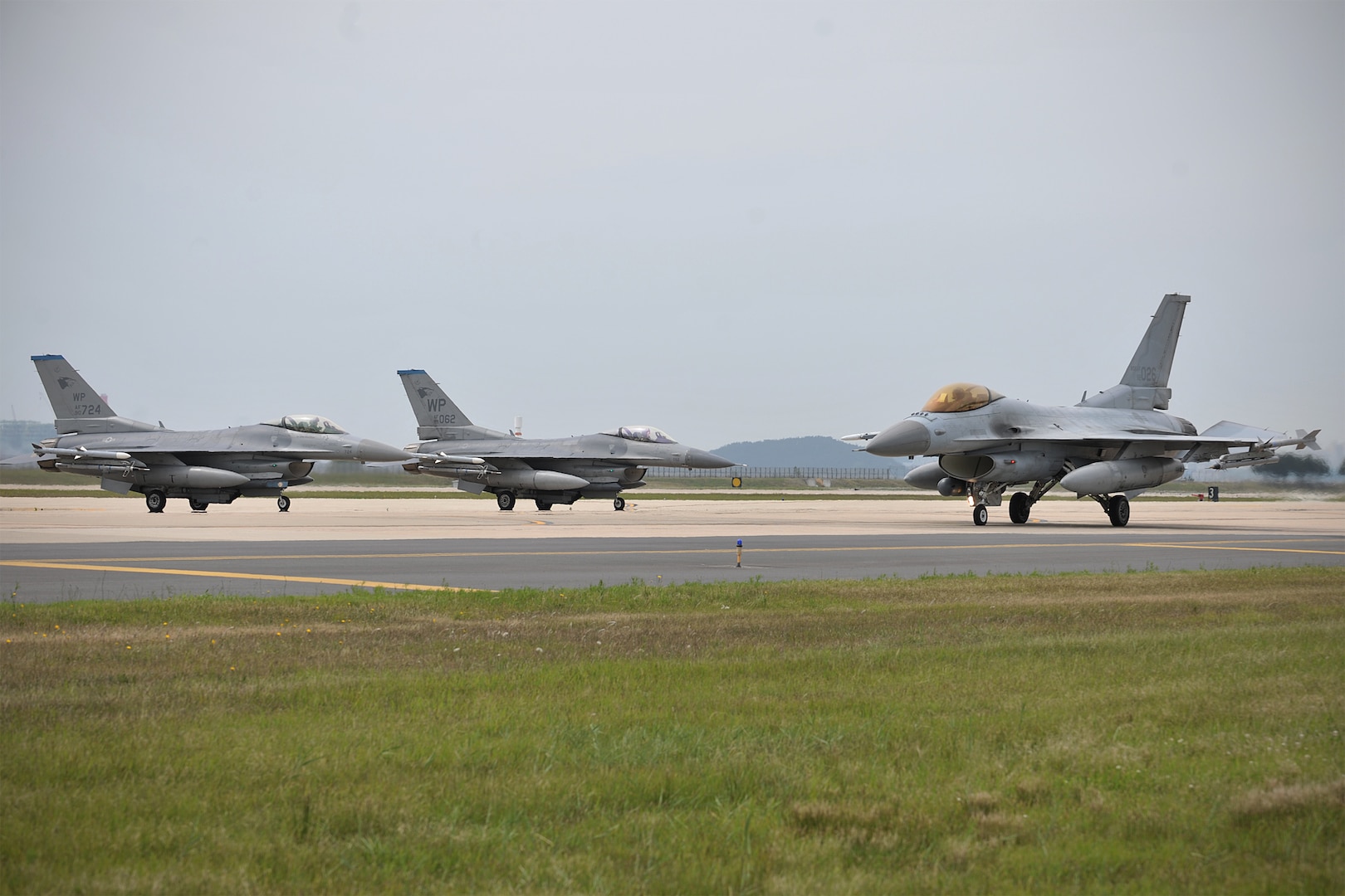 A Republic of Korea Air Force KF-16 Fighting Falcon from the 123rd Fighter Squadron, Seosan Air Base, taxis on the flightline as two 35th Fighter Squadron F-16 Fighting Falcons prepare to taxi for a sortie at Kunsan Air Base, ROK, during Exercise Buddy Wing 15-4, June 4, 2015. In an effort to enhance U.S. and ROKAF combat capability, Buddy Wing exercises are conducted multiple times throughout the year on the peninsula to sharpen interoperability between the allied forces so that if need be, they are always ready to fight as a combined force. (U.S. Air Force photo by Senior Airman Katrina Heikkinen/Released)