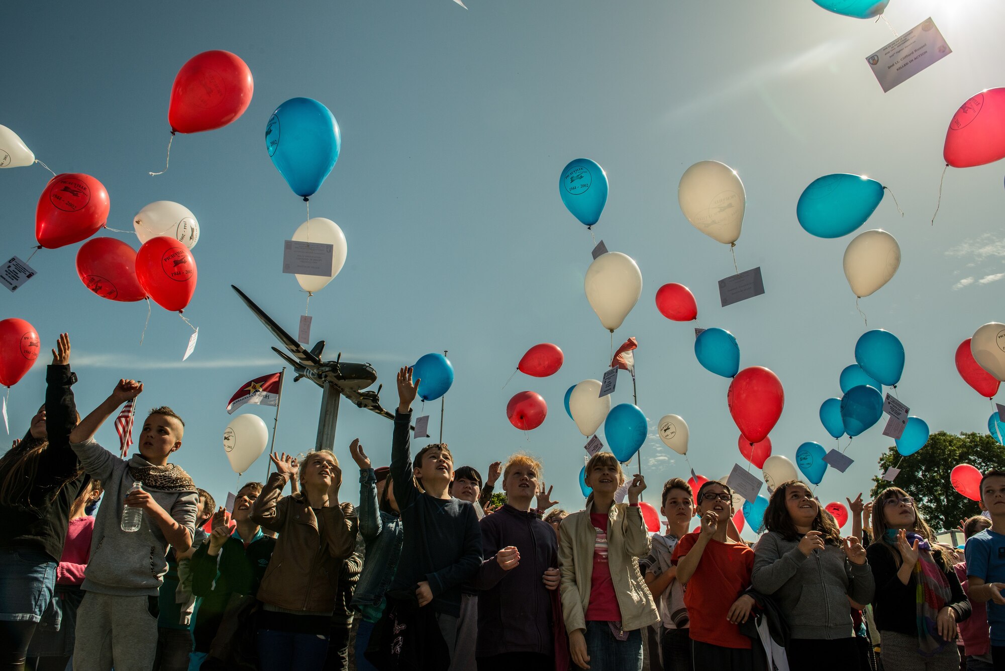 French children let balloons soar into the sky to celebrate the service of the U.S. military during D-Day June 4, 2015, Normandy, France. More than 380 servicemembers from Europe and affiliated D-Day historical units are participating in the 71st Anniversary as part of Joint Task Force D-Day 71. The task force, based in Saint Mere Eglise, France, is supporting local events across Normandy, from 2-8 June, 2015 to commemorate the selfless actions by all the Allies on D-Day that continue to resonate 71 years later. (U.S. Air Force photo/Senior Airman Nicole Sikorski)