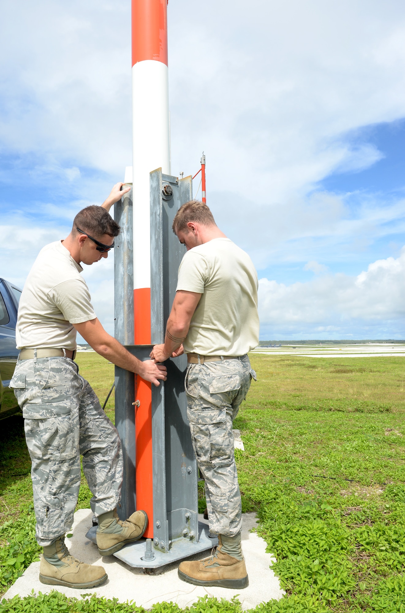 Airfield systems Airmen from the 36th Operations Support Squadron return the wind bird to standing position after performing checks on the instrument’s performance June 2, 2015, at Andersen Air Force Base, Guam. The instrument is a sensor that determines the direction of the wind and is one of many sophisticated pieces of equipment maintained by airfield systems technicians to ensure aircrews remain safe throughout their missions. (U.S. Air Force photo by Senior Airman Amanda Morris/Released)