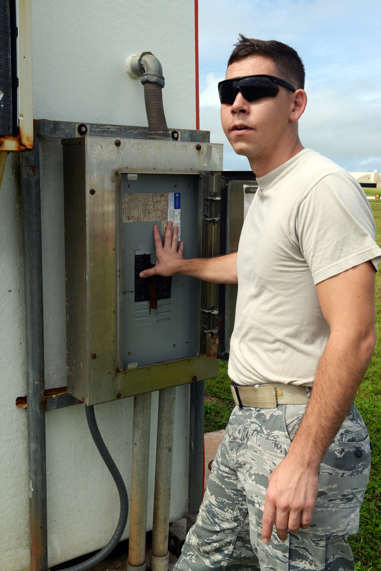 Senior Airman Patrick Duffie, 36th Operations Support Squadron airfield systems technician, flips breaker switches to ensure power is being properly dispersed to the wind bird, a wind sensor, June 2, 2015, at Andersen Air Force Base, Guam. The technicians guarantee safe landings everyday by performing routine checks on essential equipment such as the glideslope, localizer, and TACAN or tactical air navigation. (U.S. Air Force photo by Senior Airman Amanda Morris/Released)