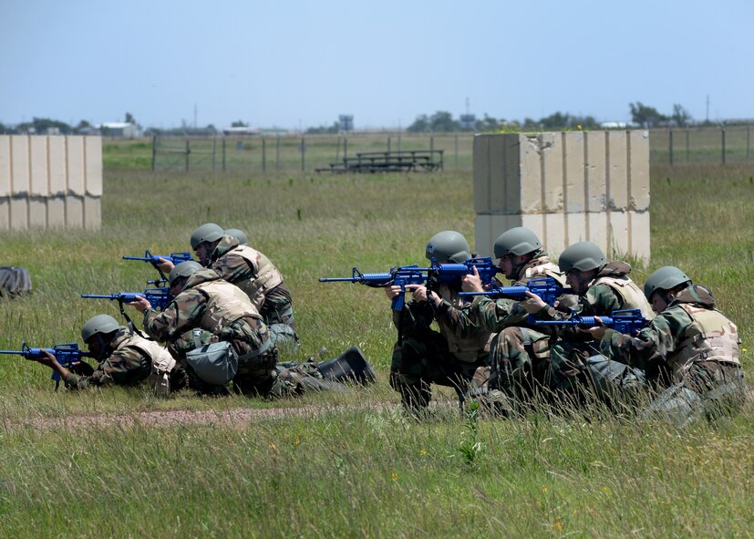 U.S. Air Force contracting Airmen respond to simulated enemy gunfire, June 3, 2015 at Altus Air Force Base, Oklahoma. The Airmen participated in field training while having to complete the mission of a contracting office. (U.S. Air Force photo by Airman 1st Class Kirby Turbak)