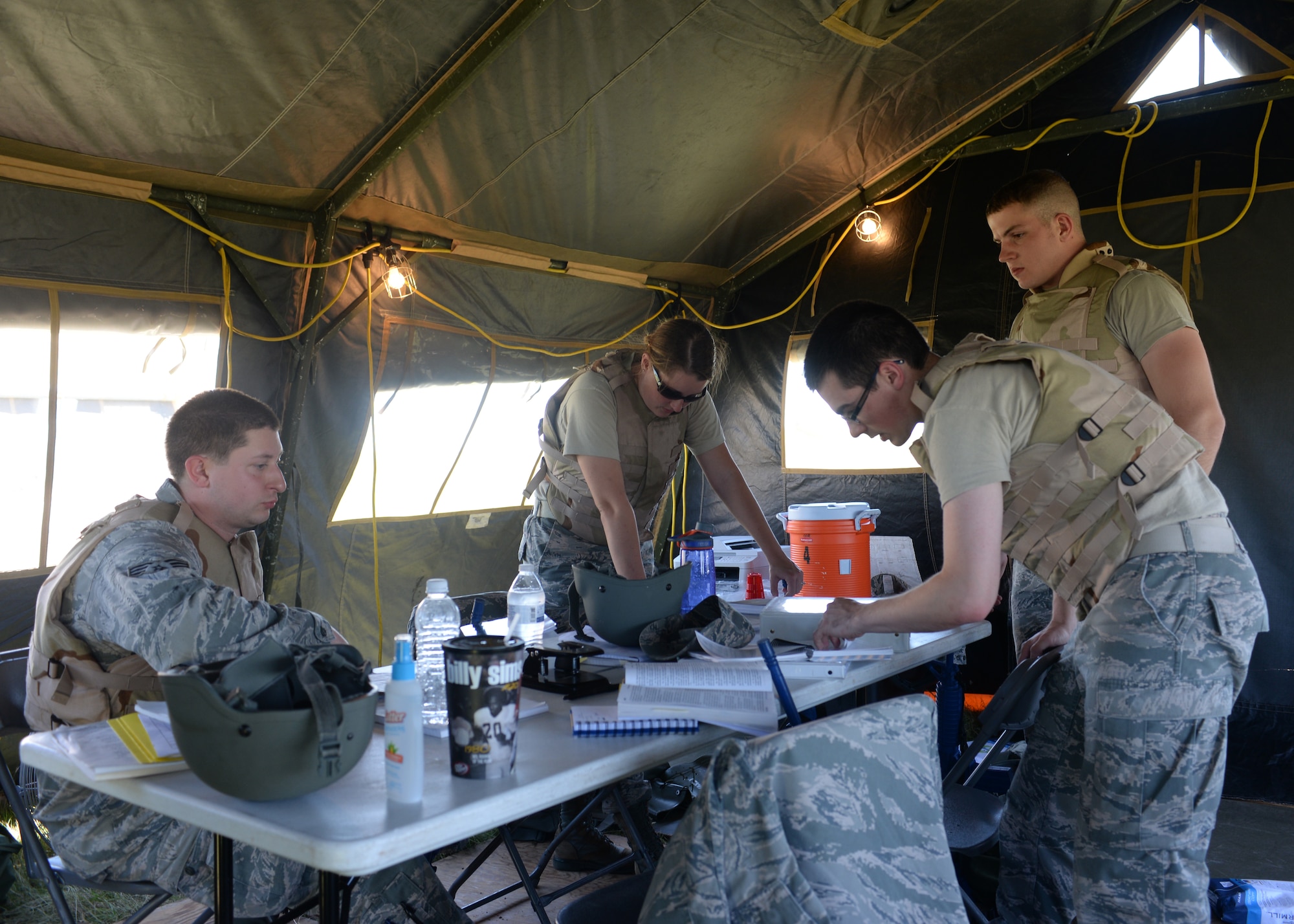 U.S. Air Force contract specialists from Altus Air Force Base and Sheppard Air Force Base, Texas prepare contracts for simulated vendors at Altus Air Force Base, Oklahoma, June 3, 2015. The Airmen completed simulated contracts to provide their base with water and other essentials. (U.S. Air Force photo by Airman 1st Class Kirby Turbak)