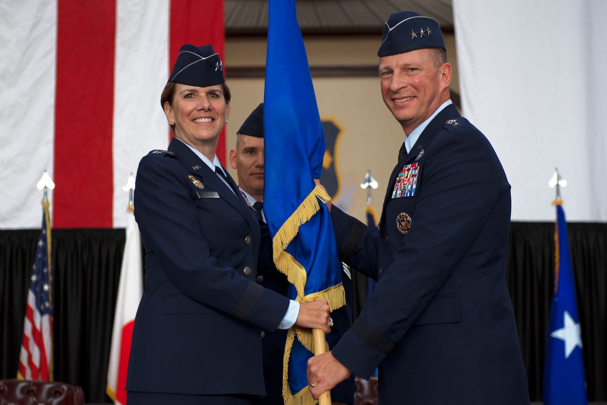 Gen. Lori J. Robinson, the Pacific Air Forces commander, passes the U.S. Forces Japan guidon to the new U.S. Forces Japan and 5th Air Force Commander Lt. Gen. John L. Dolan, during a change of command ceremony June 5, 2015, at Yokota Air Base, Japan. The passing of the guidon marks the beginning of Dolan's tour as the commander of the USFJ and 5th Air Force. (U.S. Air Force photo/Airman 1st Class Delano Scott) 