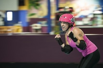 U.S. Air Force Master Sgt. Erica Hidalgo, San Angelo Roller Girls member, celebrates after scoring during a bout at The Rink in San Angelo, Texas. Hidalgo has been participating in roller derby since January, 2015 as part of a New Year’s resolution. (U.S. Air Force photo by Staff Sgt. Michael Smith)