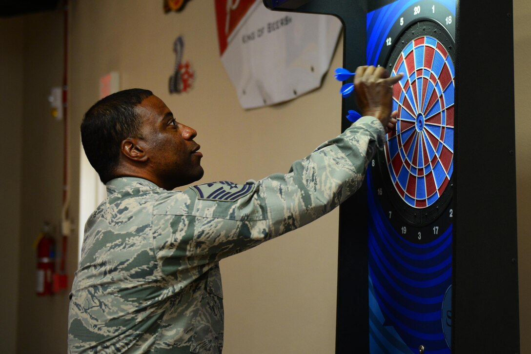 U.S. Air Force Master Sgt. Christopher Williams, 27th Special Operations Force Support Squadron first sergeant, tallies up his score at the renovated Drop Zone’s new electronic dart boards June 4, 2015 at Cannon Air Force Base, N.M. The facility’s bar area also features pool tables, card games and air hockey. (U.S. Air Force Photo/Airman 1st Class Shelby Kay-Fantozzi)