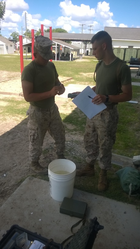 Marines from BWST 6-15 conduct a performance test on Water Quality Analysis Set-Purification.