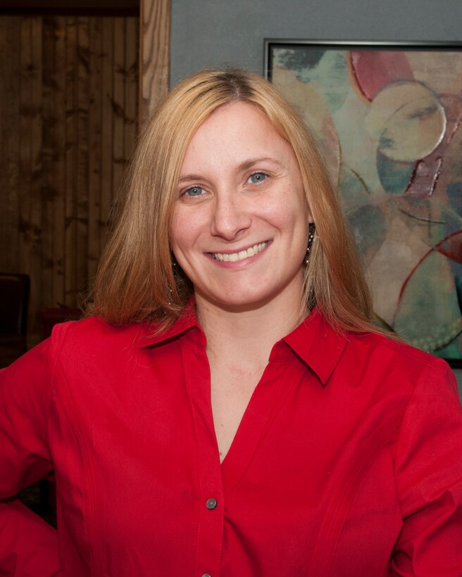 Christina Hebert, 90th Security Forces Squadron key spouse, poses at her work in Cheyenne, Wyo., June 2, 2015. Hebert and her fellow key spouses act as a liaison between military families and squadron leadership. (U.S. Air Force photo by Senior Airman Jason Wiese)