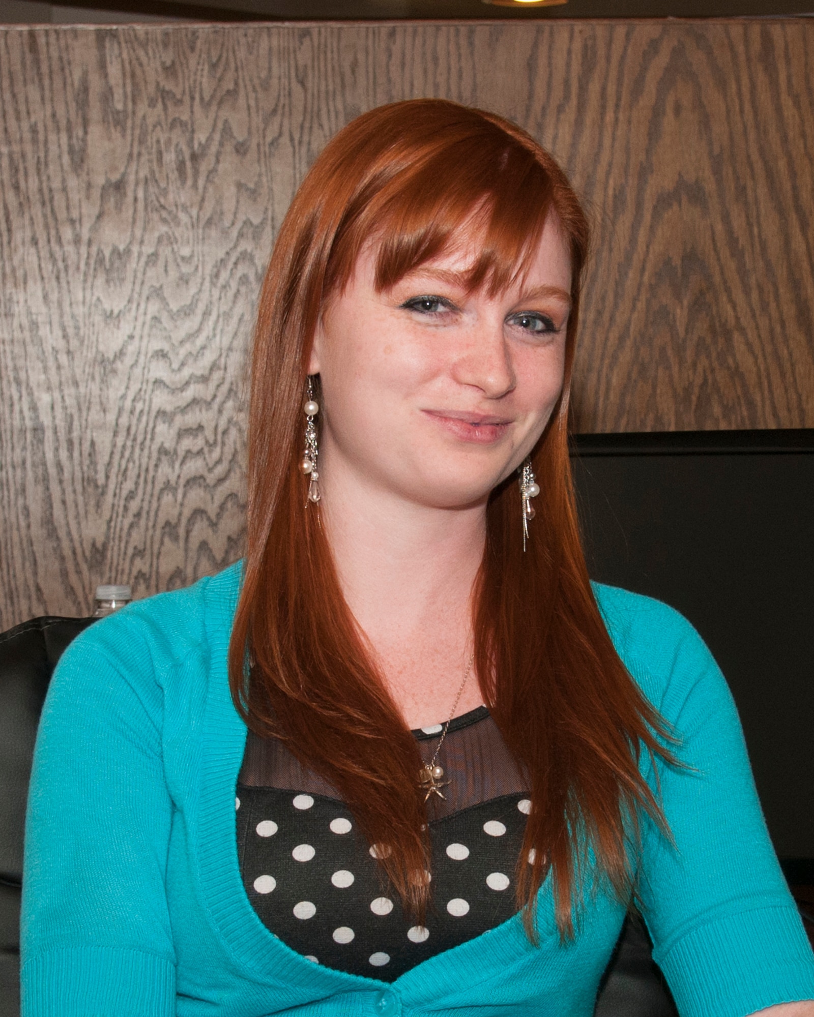 Aimee Mullins, 90th Security Forces Squadron key spouse, poses at her work in Cheyenne, Wyo., June 2, 2015. Mullins and her fellow key spouses p a liaison between military families and squadron leadership. (U.S. Air Force photo by Senior Airman Jason Wiese)