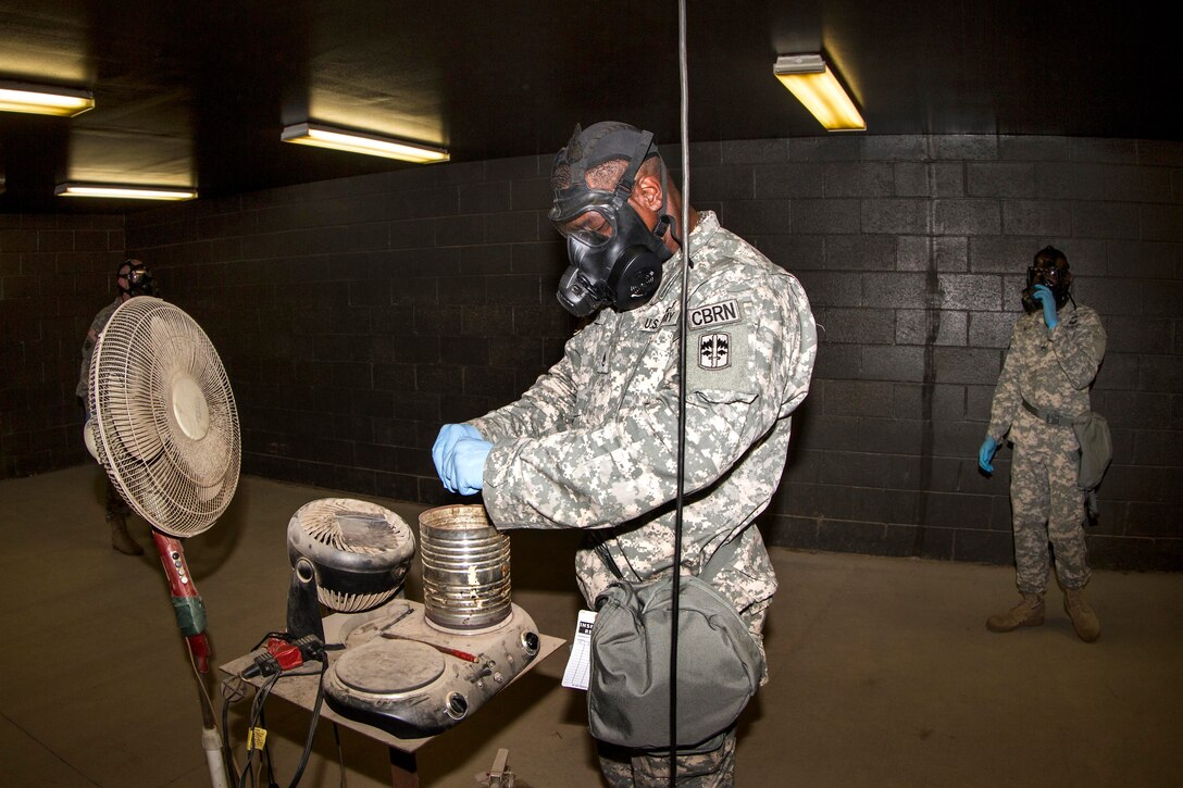 A soldier prepares the CS gas, which is similar to tear gas, for the chaplain candidates at the chemical, biological, radiological and nuclear defense chamber on Fort Jackson, S.C., May 27, 2015.