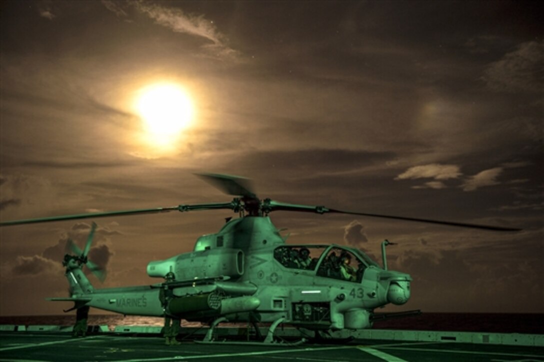 Marines work on an AH-1 Cobra helicopter on the flight deck of the amphibious transport dock ship USS Anchorage in the Pacific Ocean, June 2, 2015. The Marines are assigned to Marine Medium Tiltrotor Squadron 161.