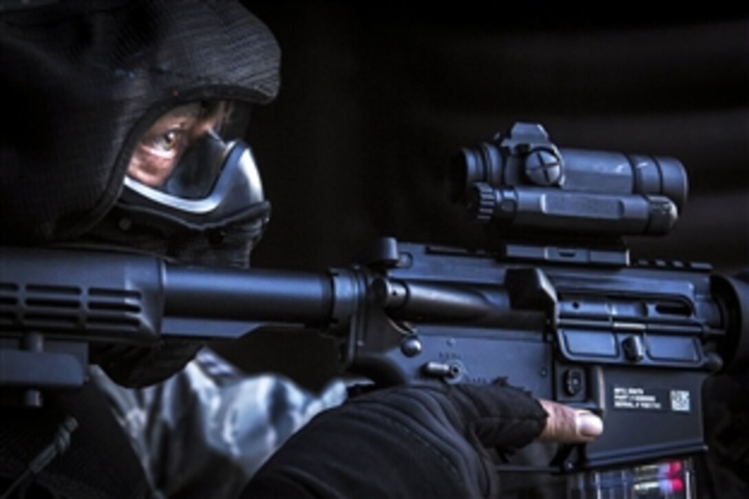 A U.S. airman secures the outside of a hardened facility after neutralizing the opposing force during combat training on Ramstein Air Base, Germany, May 30, 2015. The training teaches international security forces members advanced tactics and shooting skills in the event of a base security breach. 