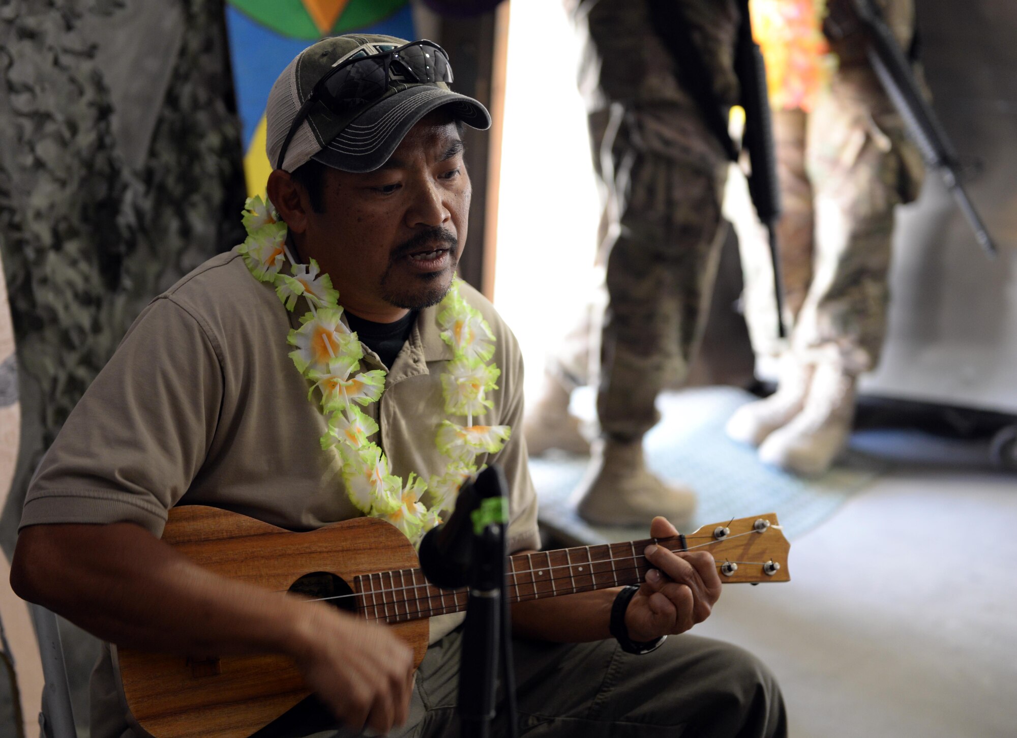 Clyd Sadang, 455th Expeditionary Security Forces Squadron contract engineer, plays a ukulele during the Bagram culture day event June 5, 2015 at Bagram Airfield, Afghanistan. The event was held to bring members of different backgrounds from across BAF together to learn and share each other’s cultures. (U.S. Air Force photo  by Senior Airman Cierra Presentado/ Released)