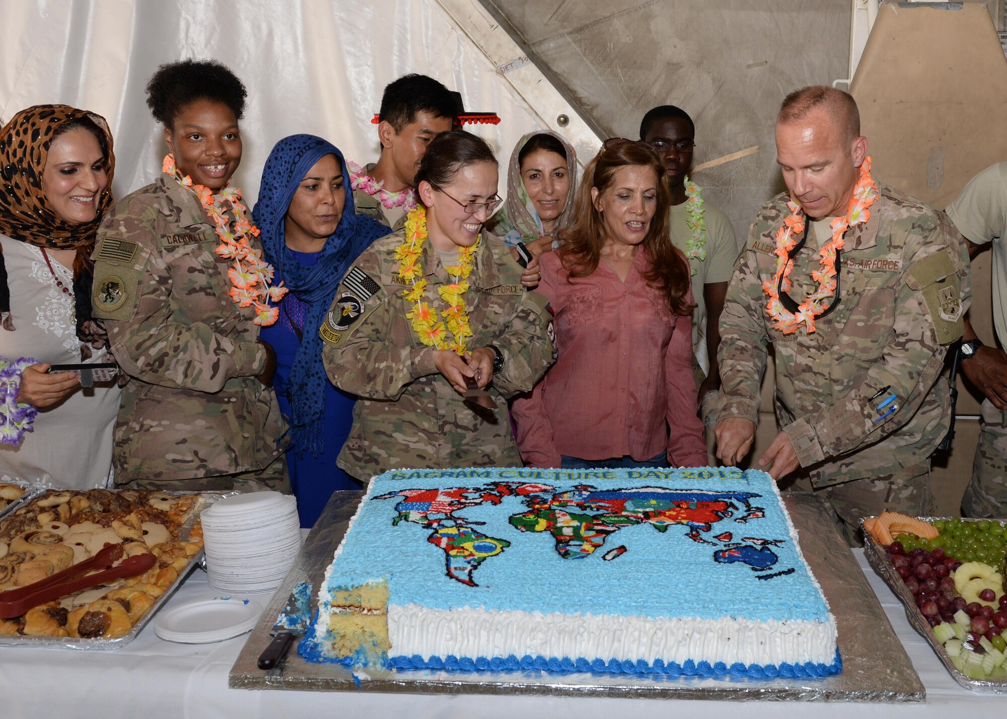 U.S. Air Force Col. Nathan Allerheiligen, 455th Air Expeditionary Wing vice commander, cuts a cake during the Bagram culture day event June 5, 2015, at Bagram Airfield, Afghanistan. The event was held to bring members of different backgrounds across BAF to learn and share each other’s cultures. (U.S. Air Force photo  by Senior Airman Cierra Presentado/ Released)  