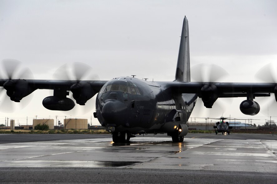 A C-130H Hercules from the Wyoming Air National Guard taxis to its parking spot as an HH-60 Pave hawk waits during an Angel Thunder 2015 mass casualty exercise at Winslow-Lindbergh Regional Airport, Ariz., June 5, 2015. The C-130H transported medical equipment, service members and students from the University of Arizona and Northern Arizona University to the training locations in northern Arizona. (U.S. Air Force photo/Tech. Sgt. Courtney Richardson/Released)