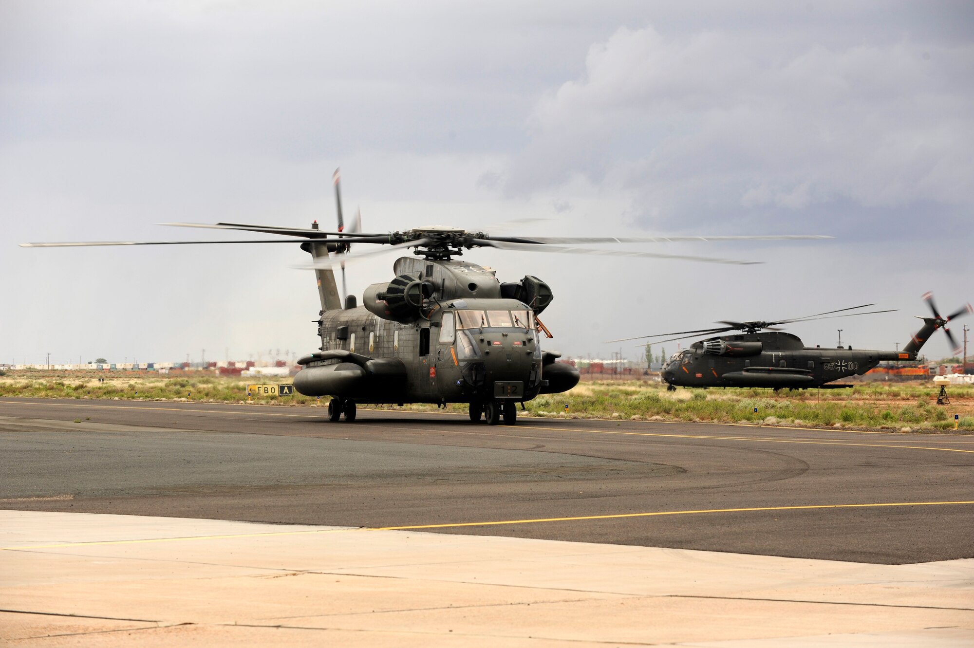 Two German Air Force CH-53GS land at Winslow-Lindbergh Regional Airport, Ariz., with simulated flood patients on board during an Angel Thunder 2015 mass casualty exercise June 5, 2015. U.S. military forces and partner-nations worked together during the exercise to transport simulated patients from Camp Navajo Training Site to the casualty collection point located at the Winslow-Lindbergh Regional Airport. (U.S. Air Force photo/Tech. Sgt. Courtney Richardson/Released)