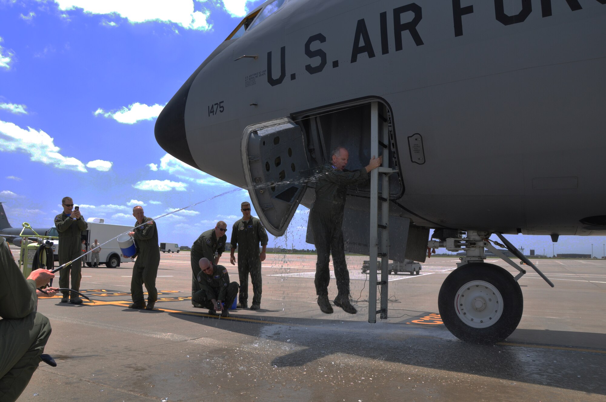Lt. Col. Eric Vitosh, 18th Air Refueling Squadron Commander, is greeted by a blast of cold water upon exiting a KC-135 Stratotanker at McConnell Air Force Base, Kan., June 6, 2015.  Vitosh had just completed his "Fini Flight" with the 18 ARS, having flown his final mission as a member of the unit.  Vitosh assumed command of the 18 ARS in May 2012.  He began his enlisted career in 1987 and was accepted into the Air Force Academy in 1988 as part of the Enlisted Airman Development Program. Following his graduation from the Air Force Academy in 1993, he began Air Force Pilot Training and graduated in 1994.
Vitosh served in a variety of capacities during an active duty career that spanned more than a decade. In 2002, he joined the Air Force Reserve as a member of the 18th Air Refueling Squadron at McConnell Air Force Base, Kan. He has served on several deployments to locations in both Europe and Southwest Asia.  (U.S. Air Force photo by Tech. Sgt. Abigail Klein)
