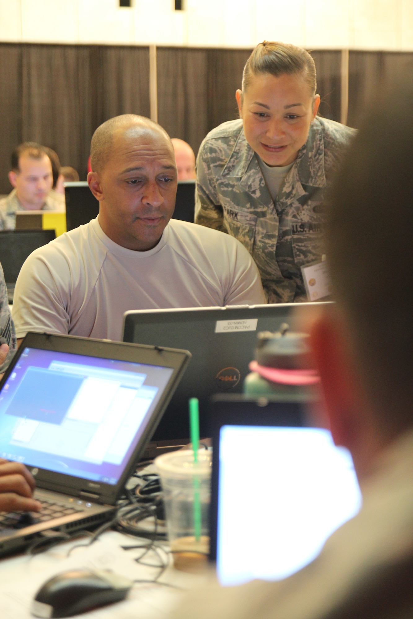 Senior Airman Jasper Green, from the 292nd Combat Communications Squadron, and Master Sgt. Misty Park, from the 209 Air Operations Group, Hawaii Air National Guard, attempt to resolve a cyber attack during the Po’oihe 2015 Cyber Security Exercise at the University of Hawaii Manoa Campus Center Ballroom on June 4, 2015. The exercise is designed to provide a controlled learning environment to support collaboration and education amongst all participants. (U.S. Air National Guard photo by Airman 1st Class Robert Cabuco)
