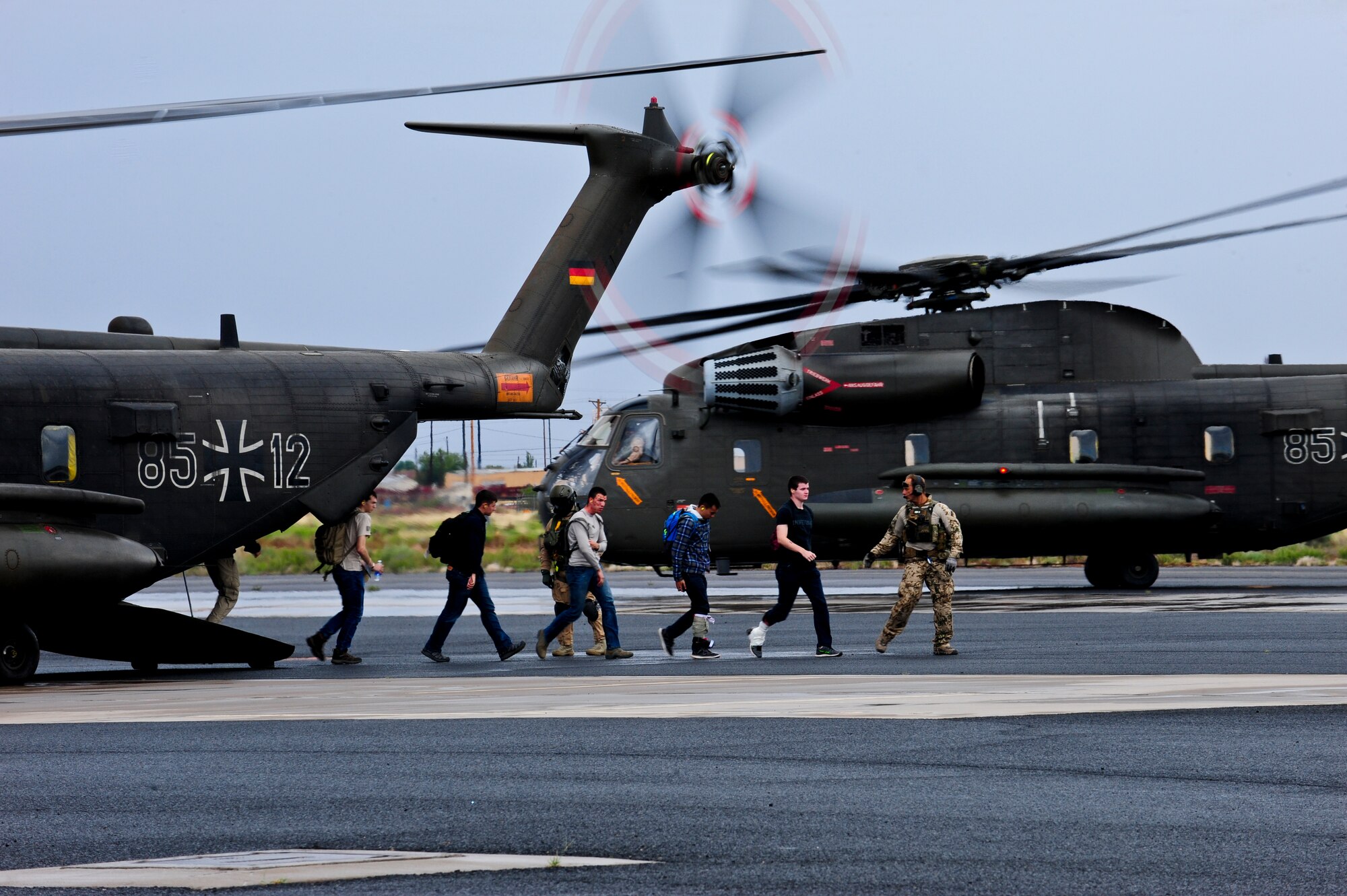 German Air Force rescue personnel lead simulated patients off of a German Army CH-53GS aircraft during an Angel Thunder 2015 mass casualty exercise at Winslow-Lindbergh Regional Airport, Ariz., June 5, 2015. U.S. military forces and partner nations worked together during the exercise to transport patients from Camp Navajo Training Site to the casualty collection point located at the Winslow–Lindbergh Regional Airport.(U.S. Air Force photo by Airman 1st Class Chris Drzazgowski/Released)