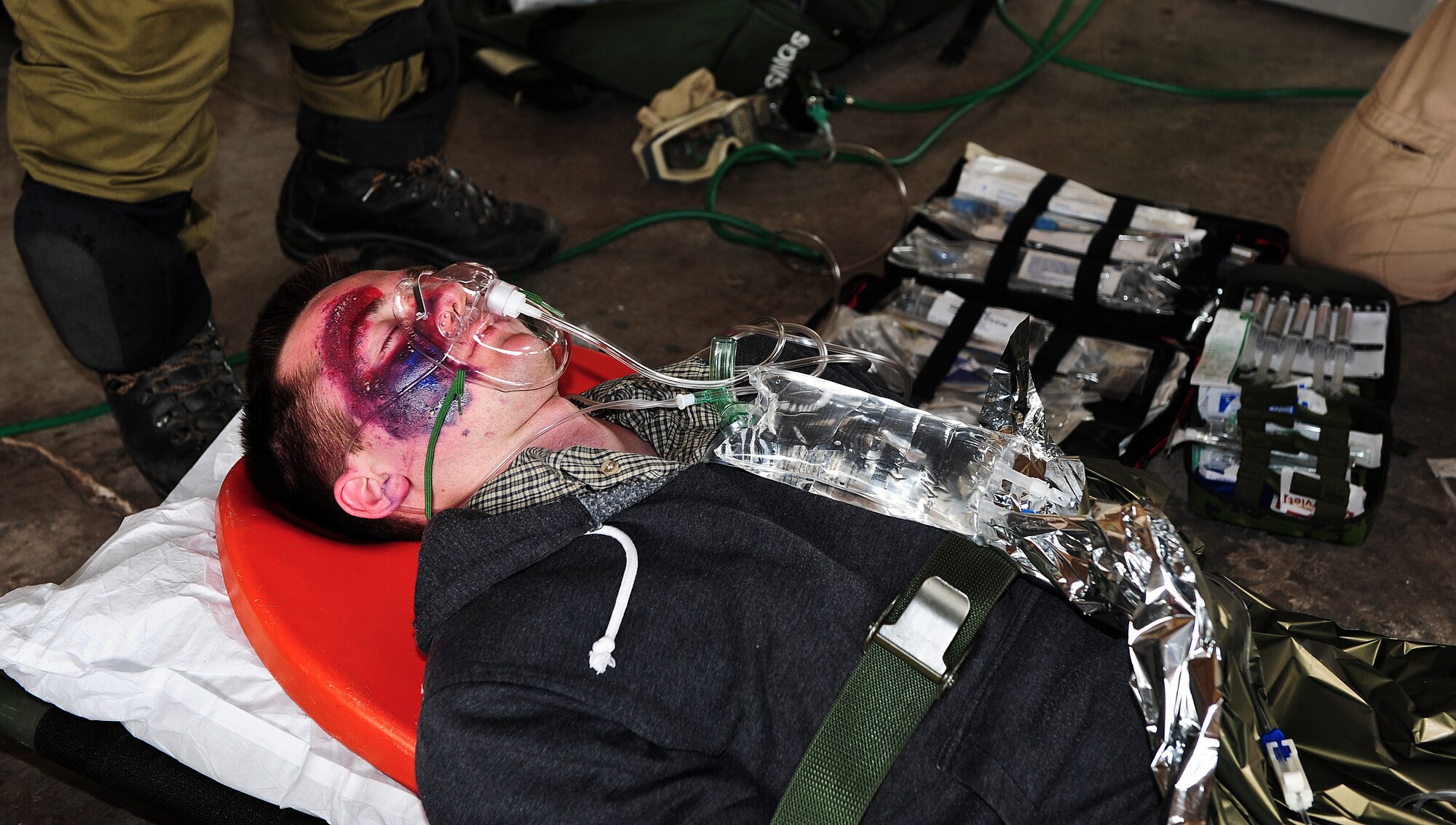Ryan Gould, Air Force Reserve Officer Training Corps cadet, is treated for a simulated traumatic brain injury during an Angel Thunder 2015 mass casualty exercise at  Winslow-Lindbergh Regional Airport, Ariz., June 5, 2015. The patients were transported from Camp Navajo Training Site to the casualty collection point where they were triaged for injuries ranging from trauma-induced child labor to scrapes. (U.S. Air Force photo by Airman 1st Class Chris Drzazgowski/Released) 