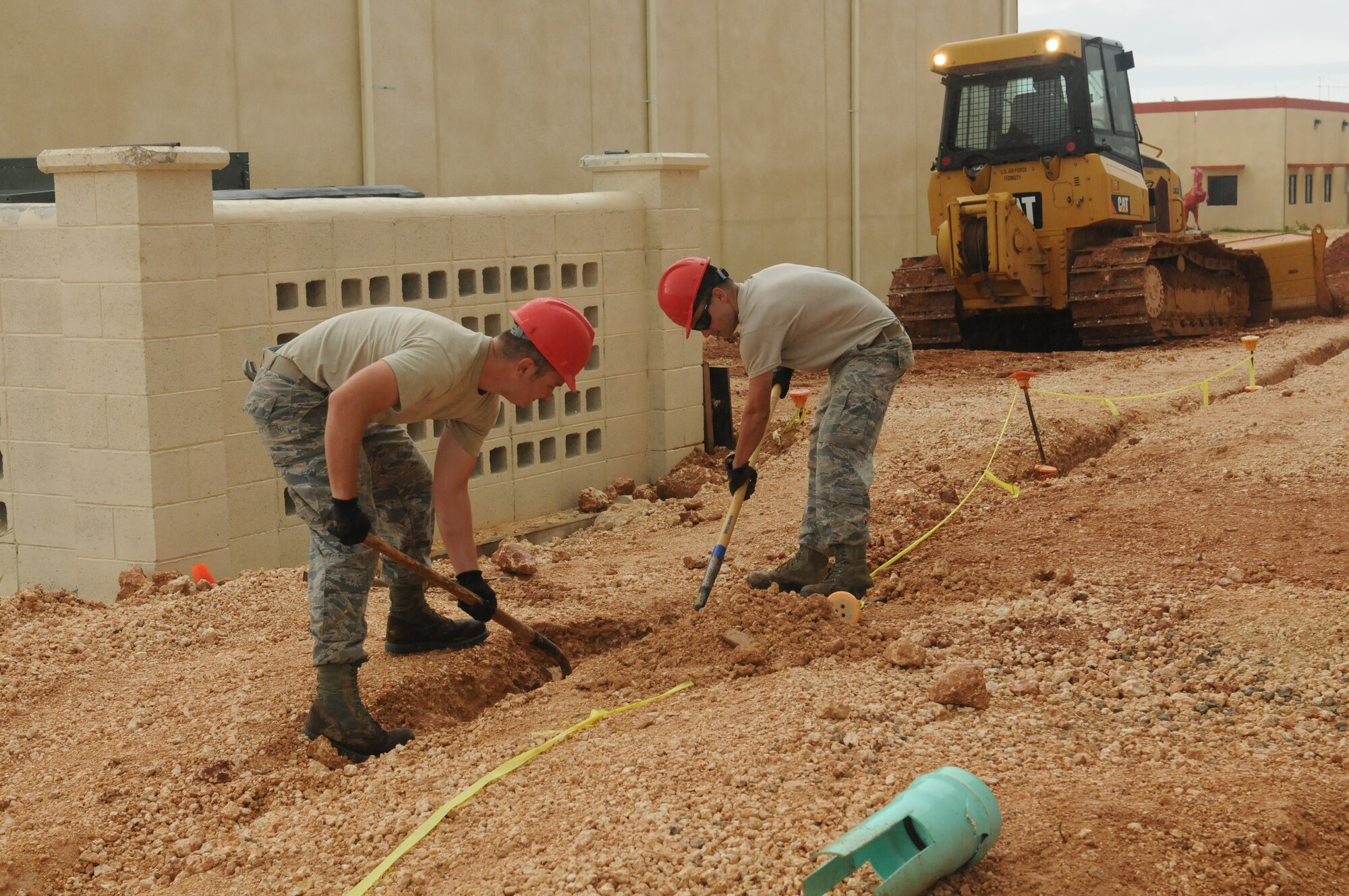 Airmen from the Virginia Air National Guard's Virginia Beach-based 203rd RED HORSE Squadron and the 202nd RHS from Camp Blanding, Florida improve and train upon essential skills June 2, 2015 during a joint-tasking training mission to erect a Facilities Systems Training facility at Anderson Air Force Base, Guam. The FST is a one-story, pre-cast concrete "Tilt-Up Construction" building using troop labor, under the Air National Guard Deployment for Training program. The facility is designed to withstand hurricane-force winds and earthquakes. (U.S. Air National Guard photo by Tech. Sgt. Meghan Skrepenski/Released)