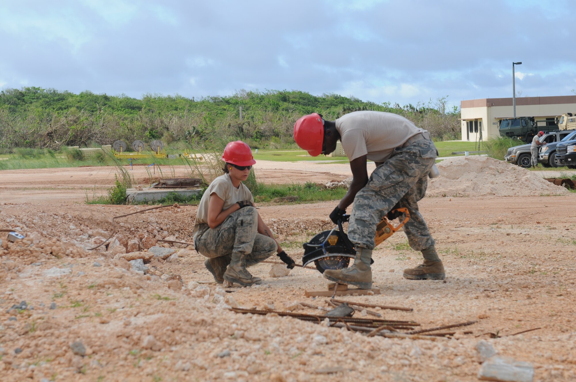 Airmen from the Virginia Air National Guard's Virginia Beach-based 203rd RED HORSE Squadron and the 202nd RHS from Camp Blanding, Florida improve and train upon essential skills June 2, 2015 during a joint-tasking training mission to erect a Facilities Systems Training facility at Anderson Air Force Base, Guam. The FST is a one-story, pre-cast concrete "Tilt-Up Construction" building using troop labor, under the Air National Guard Deployment for Training program. The facility is designed to withstand hurricane-force winds and earthquakes. (U.S. Air National Guard photo by Tech. Sgt. Meghan Skrepenski/Released)