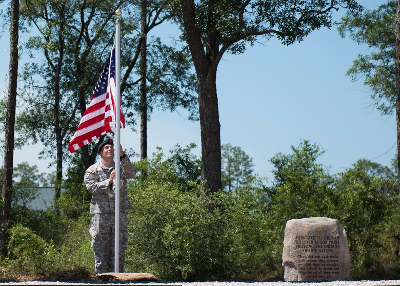 A 7th Special Forces Group Soldier raises the flag during a memorial service for 21 fallen comrades May 21 at Eglin Air Force Base, Fla.  (U.S. Air Force photo/Tech. Sgt. Jasmin Taylor)