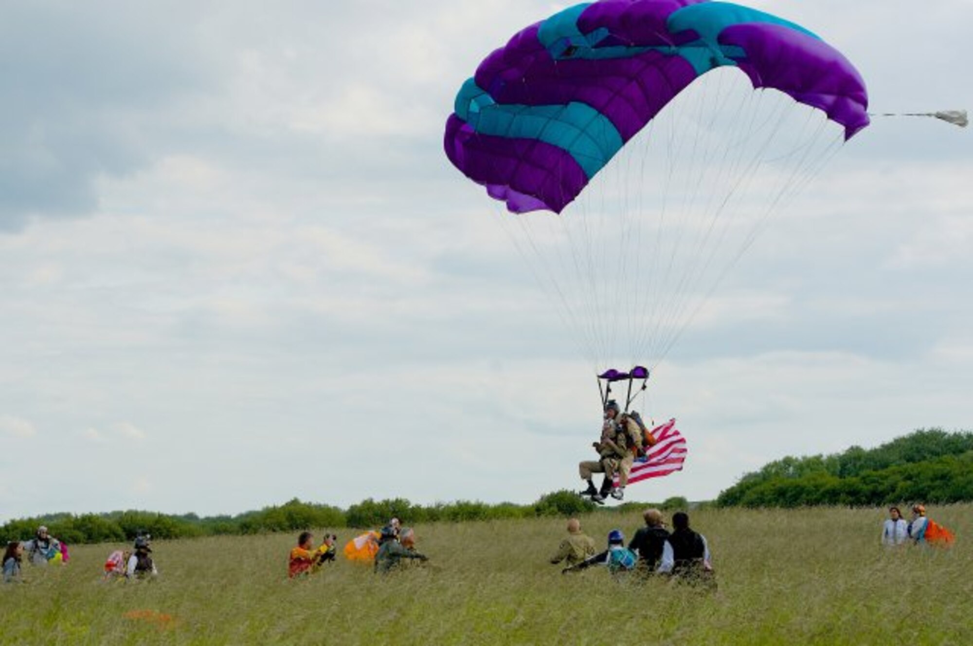 James "Pee Wee" Martin approaches for a final landing near Utah Beach, France, with tandem jump partner Dominic Kervestin, June 5, 2014. Martin is 93, and has completed a final parachute jump on the occasion of the 70th anniversary of the D-Day invasion of occupied France. (Photo by Senior Airman Alexander W. Riedel)