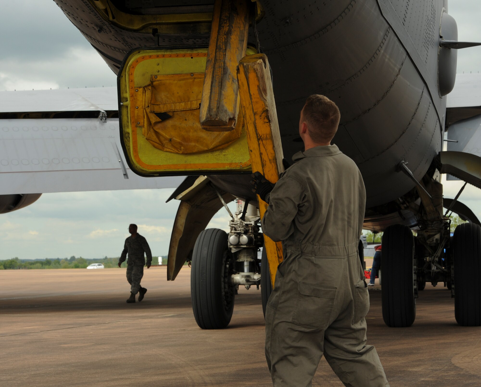 Senior Airman Jacob Tumbleson, 5th Aircraft Maintenance Squadron crew chief, grabs wheel chalks for a B-52H Stratofortress on Royal Air Force Fairford, England, June 5, 2015 after the aircraft arrived from Minot, Air Force Base, N.D. The Airmen and aircraft are forward deployed to England, to participate in the 2015 BALTOPS and Saber Strike exercises, which are multi-national training and partnership building events in Europe. (U.S. Air Force photo by Capt. Christopher Mesnard)