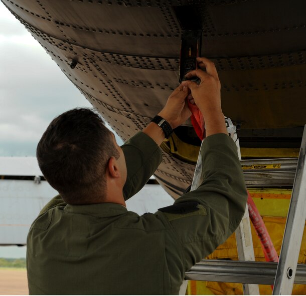 Capt. Ambrose Garcia, 23rd Bomb Squadron electronic warfare officer, attaches a remove before flight ribbon to a B-52 Stratofortress June 5, 2015 on Royal Air Force Fairford after his aircrew forward deployed from Minot to England in support of the 2015 BALTOPS and Saber Strike exercises. These exercises are designed to encourage training and interoperability between nations participating in the exercises. (U.S. Air Force photo by Capt. Christopher Mesnard)
