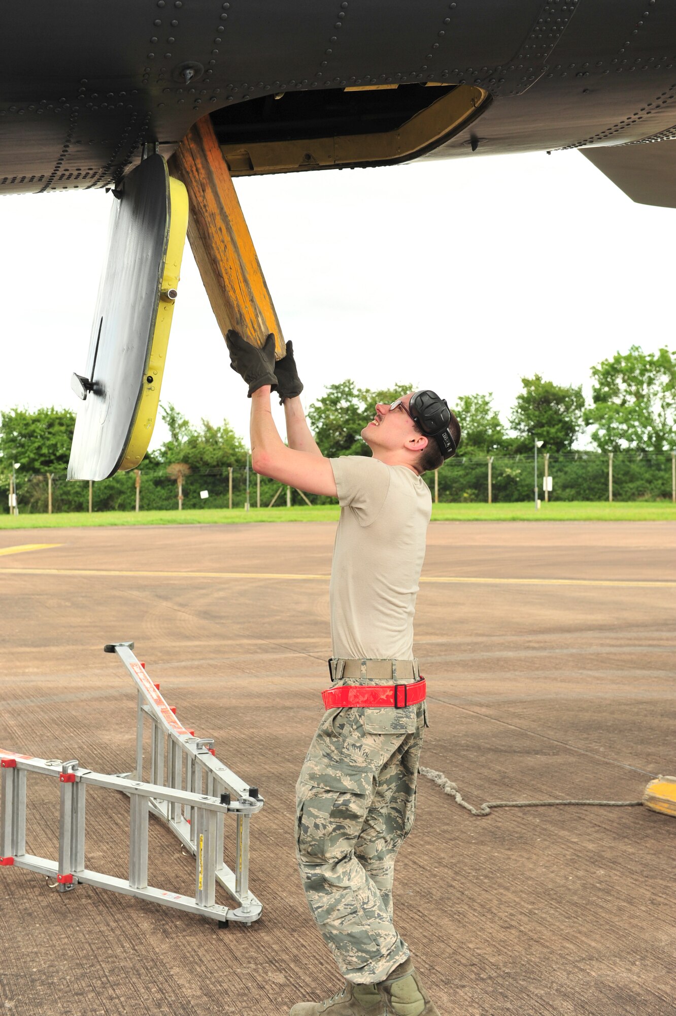 Senior Airman Zachary Silvers, 5th Aircraft Maintenance Squadron dedicated crew chief, removes chalks from a B-52H Stratofortress from Minot Air Force Base, N.D., at Royal Air Force Fairford, England, June 5, 2015. Three B-52s, maintenance crews and support teams from bases across Air Force Global Strike Command forward deployed to RAF Fairford to participate in multi-national BALTOPS and Saber Strike exercises. The purpose of BALTOPS 15 is to promote mutual understanding, confidence, cooperation and inoperability among forces and personnel of participating nation. Saber Strike is a long-standing U.S. Army Europe-led cooperative training exercise conducted annually, which aims to improve cooperation and capabilities of participating nations for future contingency operations and train participants on command and control as well as interoperability with regional partners. (U.S. Air Force photos/Senior Airman Malia Jenkins)