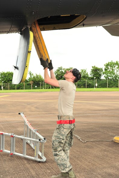 Senior Airman Zachary Silvers, 5th Aircraft Maintenance Squadron dedicated crew chief, removes chalks from a B-52H Stratofortress from Minot Air Force Base, N.D., at Royal Air Force Fairford, England, June 5, 2015. Three B-52s, maintenance crews and support teams from bases across Air Force Global Strike Command forward deployed to RAF Fairford to participate in multi-national BALTOPS and Saber Strike exercises. The purpose of BALTOPS 15 is to promote mutual understanding, confidence, cooperation and inoperability among forces and personnel of participating nation. Saber Strike is a long-standing U.S. Army Europe-led cooperative training exercise conducted annually, which aims to improve cooperation and capabilities of participating nations for future contingency operations and train participants on command and control as well as interoperability with regional partners. (U.S. Air Force photos/Senior Airman Malia Jenkins)