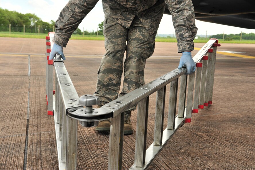 Staff Sgt. Eric Andreasens, 5th Aircraft Maintenance Squadron dedicated crew chief, picks up a ladder to inspect the engines of a B-52H Stratofortress from Minot Air Force Base, N.D., at Royal Air Force Fairford, England, June 5, 2015. Three B-52s, maintenance crews and support teams from bases across Air Force Global Strike Command forward deployed to RAF Fairford to participate in multi-national BALTOPS and Saber Strike exercises. The purpose of BALTOPS 15 is to promote mutual understanding, confidence, cooperation and inoperability among forces and personnel of participating nation. Saber Strike is a long-standing U.S. Army Europe-led cooperative training exercise conducted annually, which aims to improve cooperation and capabilities of participating nations for future contingency operations and train participants on command and control as well as interoperability with regional partners. (U.S. Air Force photos/Senior Airman Malia Jenkins)