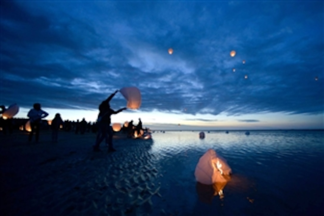Local residents of the Normandy, France, region, release paper sky lanterns June 5, 2015, to commemorate those who died here on D-Day, at a place the Allied Forces named Utah Beach for the invasion of an occupied France, 71 years ago. More than 380 American service members from Europe and affiliated D-Day historical units are participating in the 71st anniversary as part of Joint Task Force D-Day 71, June 2-8, 2015.