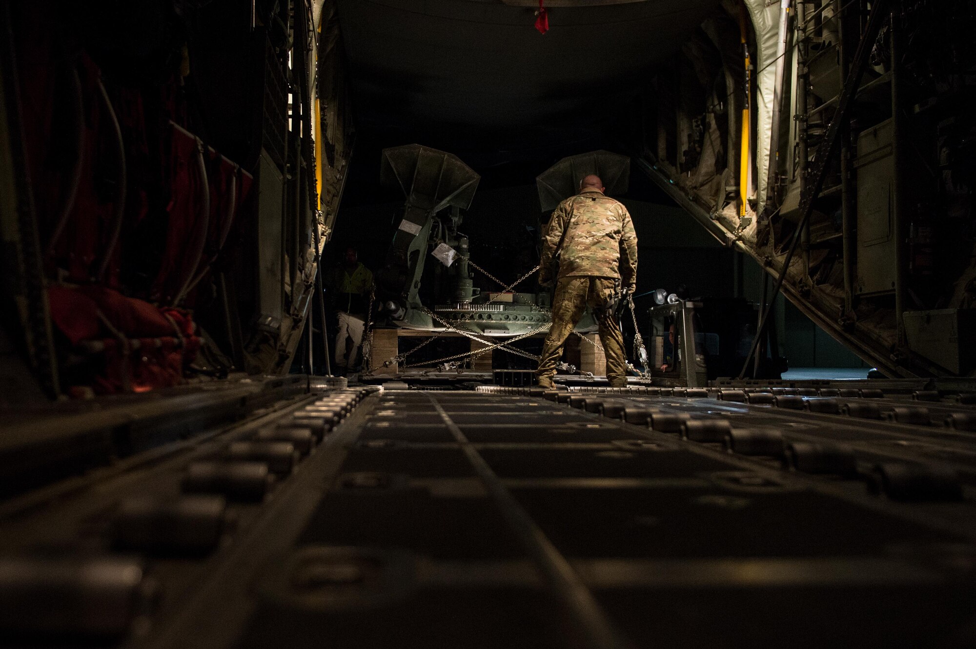 U.S. Air Force Tech. Sgt. Steve Bordenski, 774th Expeditionary Airlift Squadron loadmaster, guides a palletized howitzer onto a C-130J Super Hercules aircraft at Bagram Air Field, Afghanistan, May 25, 2015. U.S. Air Force cargo aircraft have delivered 19,900 short tons of cargo throughout Afghanistan this year. (U.S. Air Force photo by Tech. Sgt. Joseph Swafford/Released)